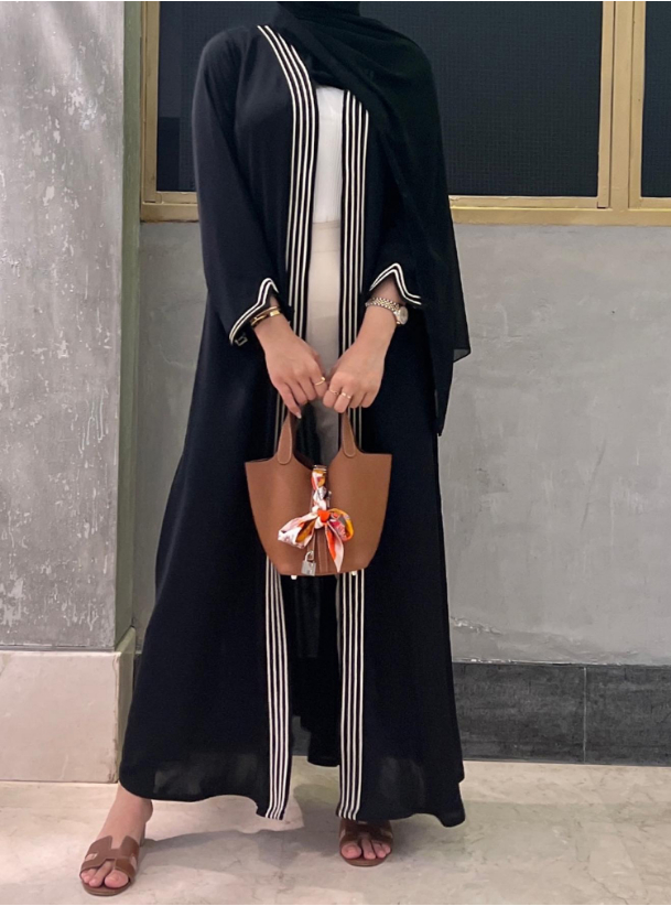 Abaya Code S19 Work with style featuring our black abaya with white contrast piping trimmings. Abayas from  at Boksha