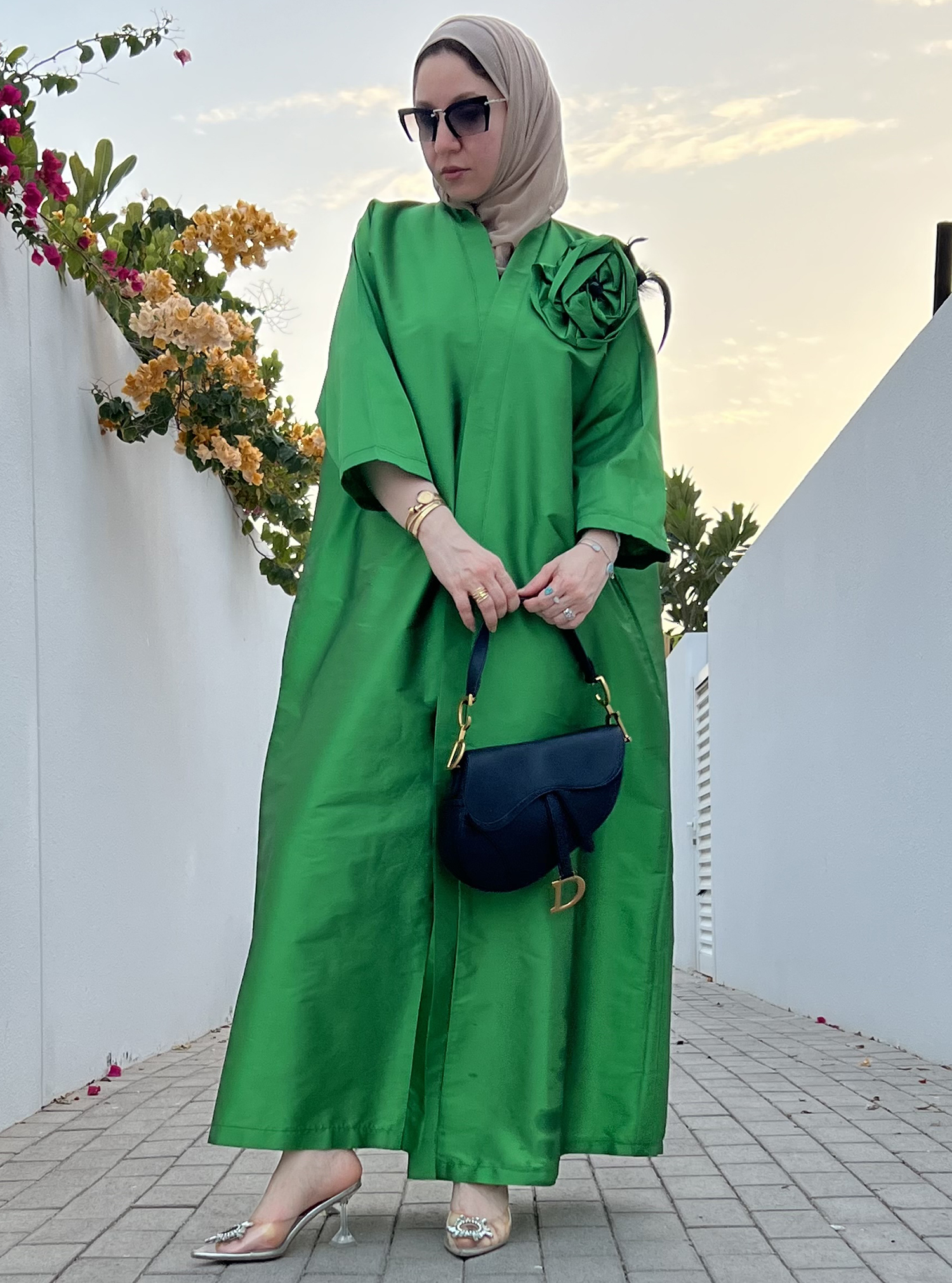 Flower green Elegant green abaya with a flower design adorned with ...